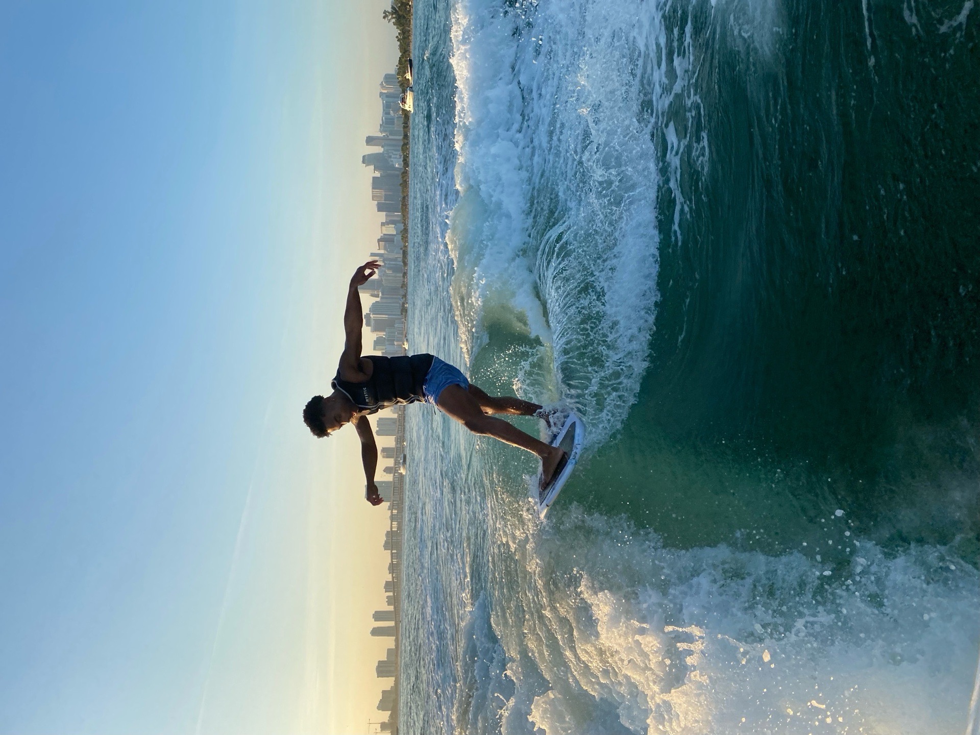 Wakesurfer riding in warm golden-hour light